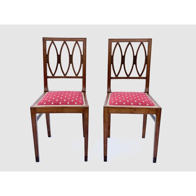 Crafted in solid wood with fine geometric inlay typical of early 20th-century German Jugendstil design. The chairs reflect...