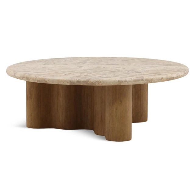 Featuring a softly rounded marble top and a sculptural wood base with gently rippled edges, this round coffee table brings...