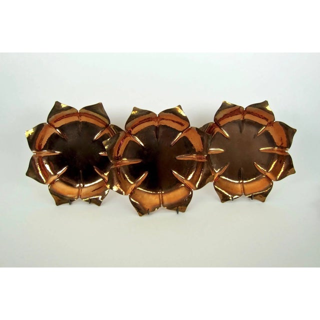 A matching set of six Arts and Crafts period fluted and flaring copper dishes / chargers by Marie Zimmermann (1879-1972),...