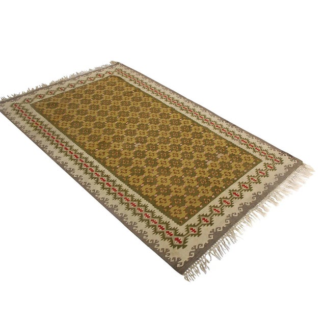 Hand woven in Turkey originating between 1950-1960, this Vintage mid-century wool kilim hails from the seaside town of...