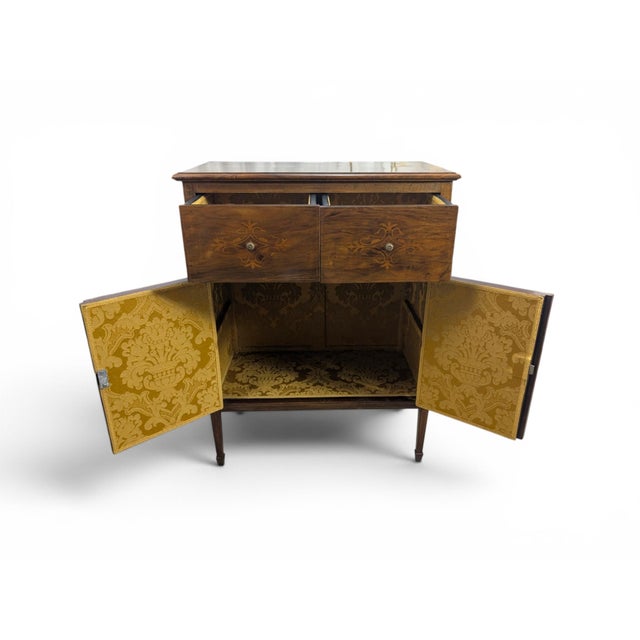This walnut piece represents a splendid example of 20th-century Italian craftsmanship, elegantly balancing the historicist...