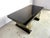 Vintage seventies glam dining table made from black lacquered wood and brass. The black lacquer with golden finish gives a...