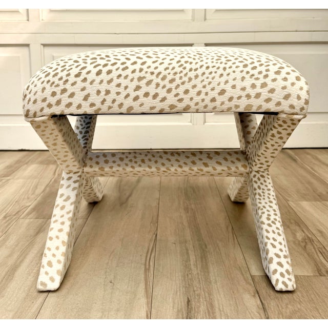 Here is a vintage X-frame vanity stool, newly reupholstered in a soft, velvet-like cream and tan animal print fabric. The...