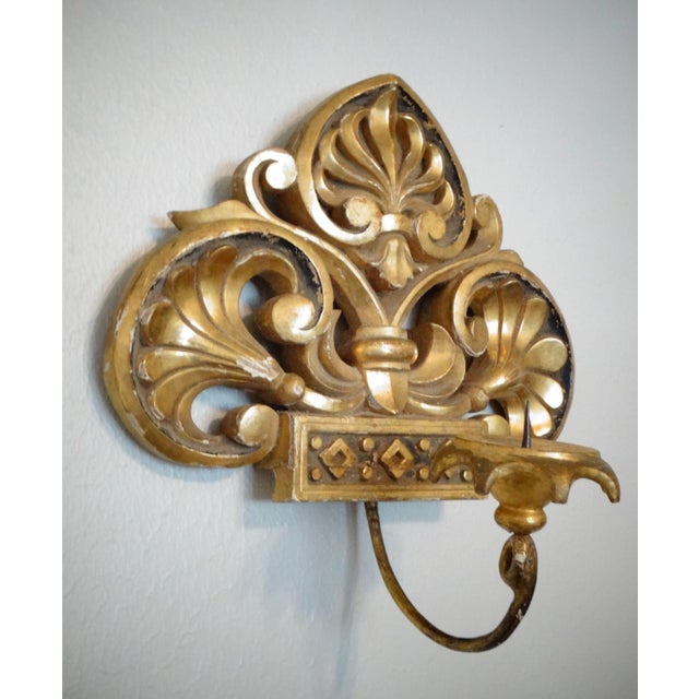 19th-Century pair of Italian giltwood hanging candle sconces. These lovely single arm wall sconces are elaborately carved...