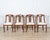 A graceful set of four Lombard gondola chairs from the first half of the 19th century, finely crafted in solid walnut....