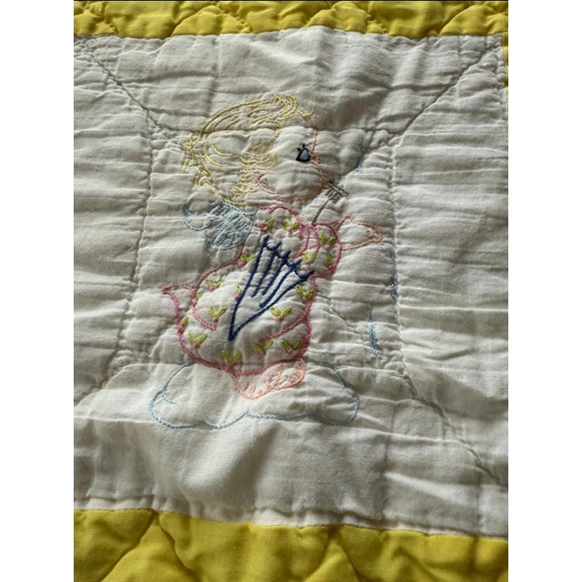 This product is a handmade vintage quilt from the 1950s, featuring a vibrant yellow color and intricate embroidered...
