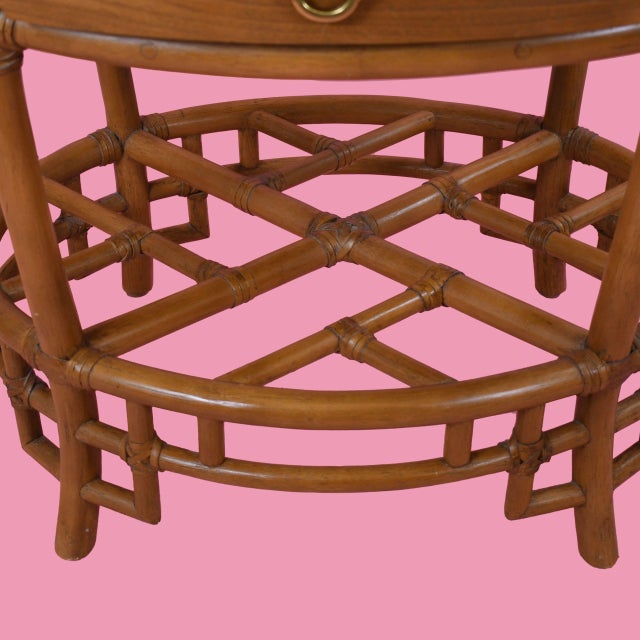 Complete your bedroom with this pair of vintage Ficks Reeds fretwork oval rattan nightstands. The quality craftsmanship...