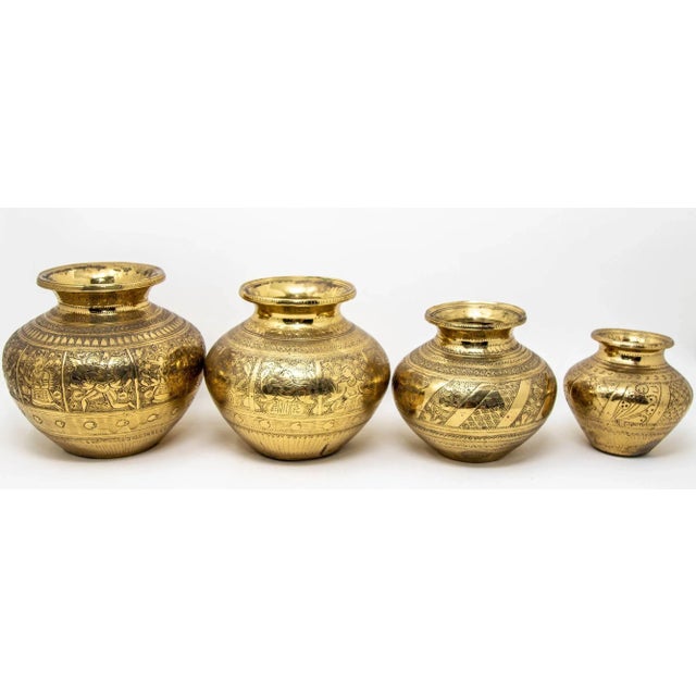 Add a touch of India's rich heritage to your home with this vintage set of four engraved brass lota from India, circa...