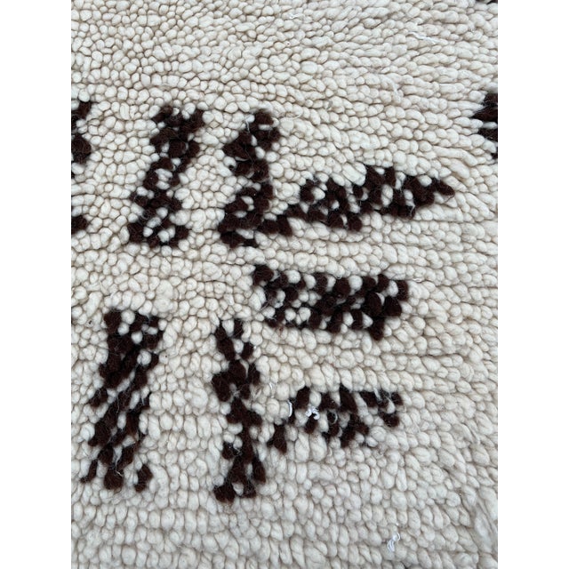 Hand-woven by the Berber women in the Atlas Mountains, this rug is created with soft natural wool fibers from the tribe’s...