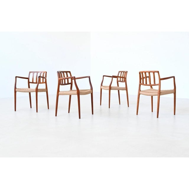 This stunning set of four Niels Otto Møller model 66 armchairs was designed and produced in Denmark in 1974. A refined...