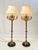 Exceptional pair of Neoclassical multi-light candelabra floor lamps. Crafted with solid brass baluster stems, turned...