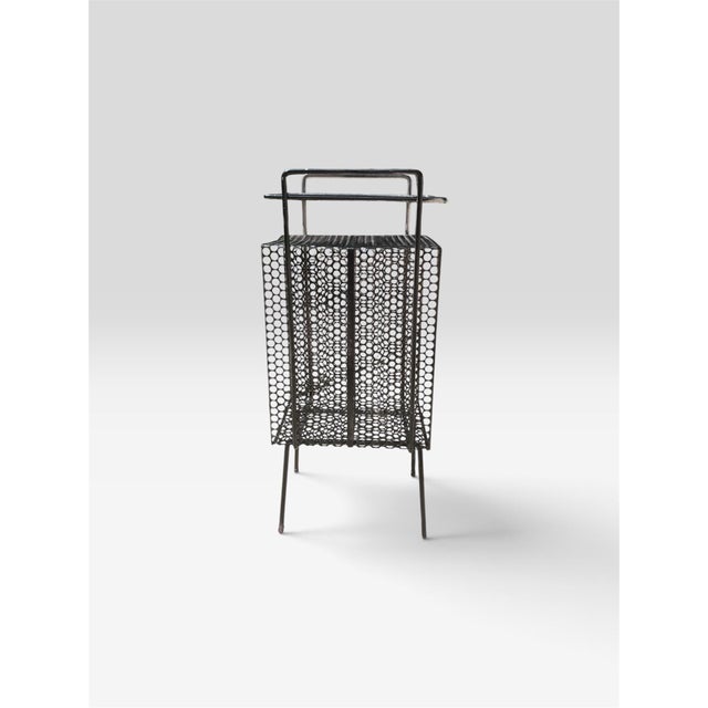 Such a fun midcentury modern telephone metal side table in the style of Richard Galen. The original paint remains on the...