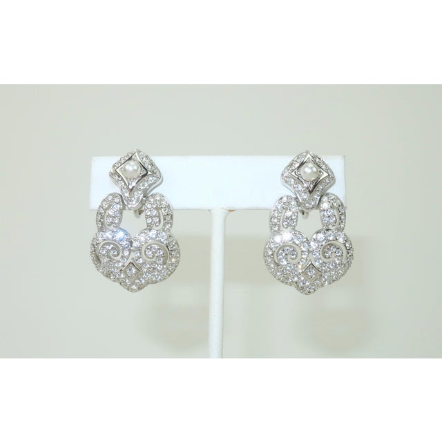 Late 20th Century door knocker style earrings by Swarovski, the Austrian brand founded in 1895 by Daniel Swarovski. These...