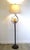A Dale Tiffany Spotted Owl floor lamp featuring a beautifully hand-crafted amber art glass owl nestled within sculptural...