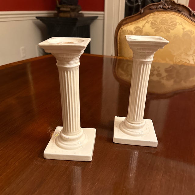 A wonderful pair of early cream ware architectural candlestick holders in the form of fluted columns with floral & egg and...