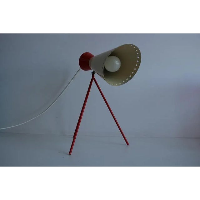 Beautiful metal lamp with adjustable shade, which has small circular holes in the front, which transmits soft light and...