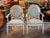A pair of 19th century Louis XVI style armchairs in a soft dove-blue painted finish, each with an oval medallion back...