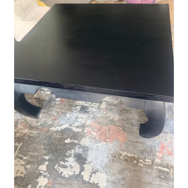 Striking solid wood opium coffee table in a rich black finish. A true statement piece, the low Ming-style silhouette with...