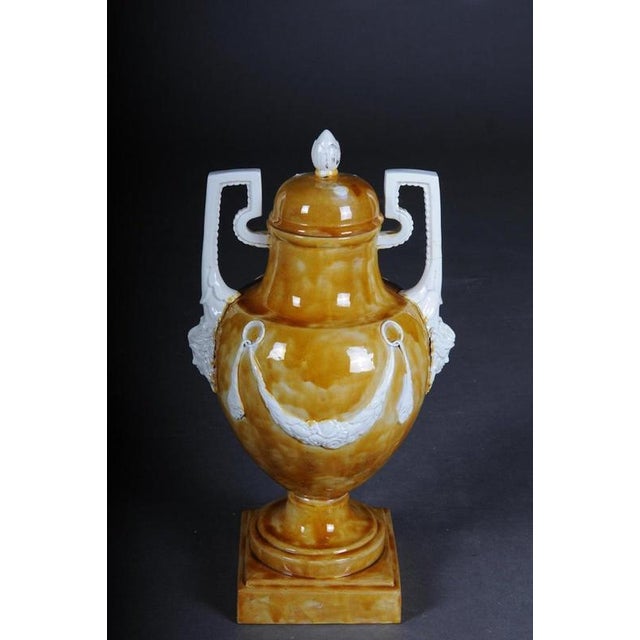 Extremely decorative Amphora vase. with beautiful mascarons. Classic style Amphora. Brown background with white Classic...