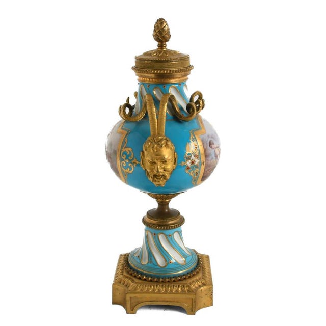 This Antique Sèvres-Style Gilt Bronze and Porcelain Painted Candlestick Urn is a stunning display of refined artistry and...