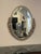 French Art Deco oval mirror with floral and geometric motifs. The frame has been re plated in a polished nickel. The...