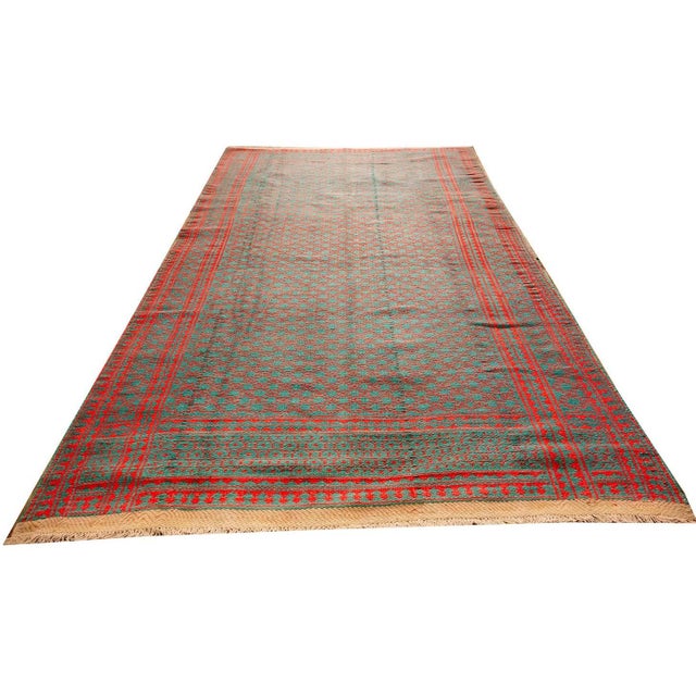 This antique Persian formal textile dating to approximately 1950, is a hand-knotted cotton piece measuring 5' 6" x 9' 5"...