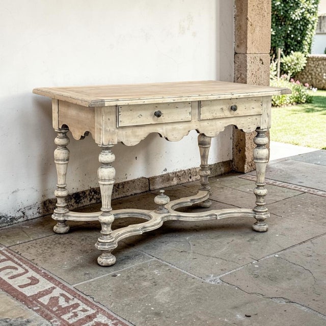 A Dutch writing table in the 18th century style, stripped to a soft, sun bleached finish that lets the natural grain of...