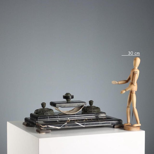 Portoro marble desk set consisting of a base, two metal ink holders with porcelain vials and a pad. This piece is...
