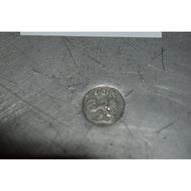 Large pair of engraved Continental pewter chargers. Largest at 13 3/4 inches in diameter, height sits at 1 3/4 inches....