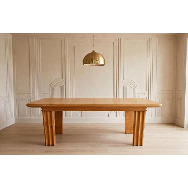 1930s Art Deco dining table in honey-colored solid wood, with curved legs featuring longitudinal grooves. Year: Circa...