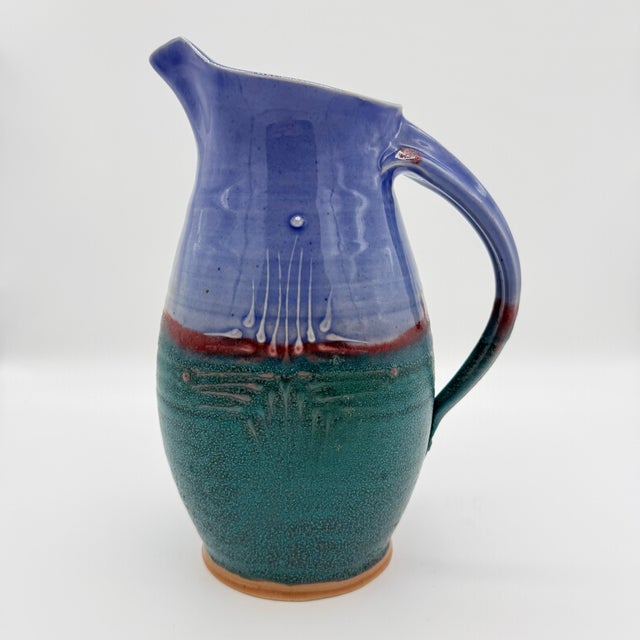 The Skinny This is the kind of pitcher that earns its place on a shelf. Hand-thrown studio pottery with a saturated...