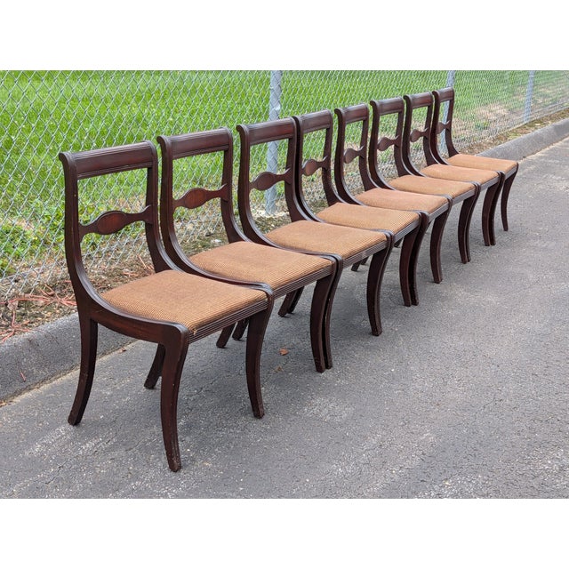 Crafted in the iconic 19th-century Neo-Classical tradition, this set of eight vintage Duncan Phyfe style dining chairs...