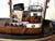 An exceptionally detailed handcrafted maritime model of the hamburg tugboat “petra”, dated 1957. Measuring only 25 cm...