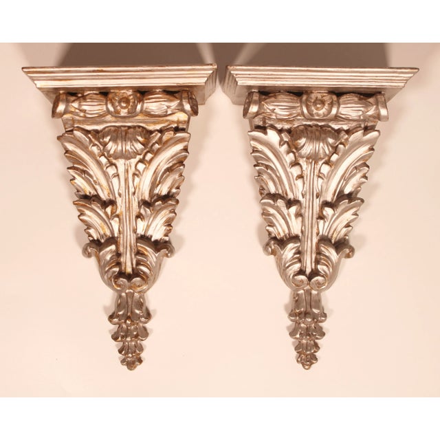 A radiant pair of vintage Italian Silver Acanthus Leaf Wooden Wall Shelves, circa 1940. These are a fabulous pair with a...