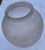 The vase pictured is a satin-finished Art Deco spherical vase made of pressed glass with a raised floral or rose pattern,...