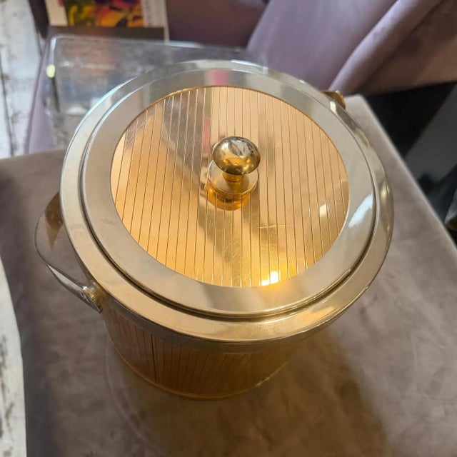 Elevate your home bar with this stunning Mid-Century Modern ice bucket, a quintessential piece of 1970s barware design by...