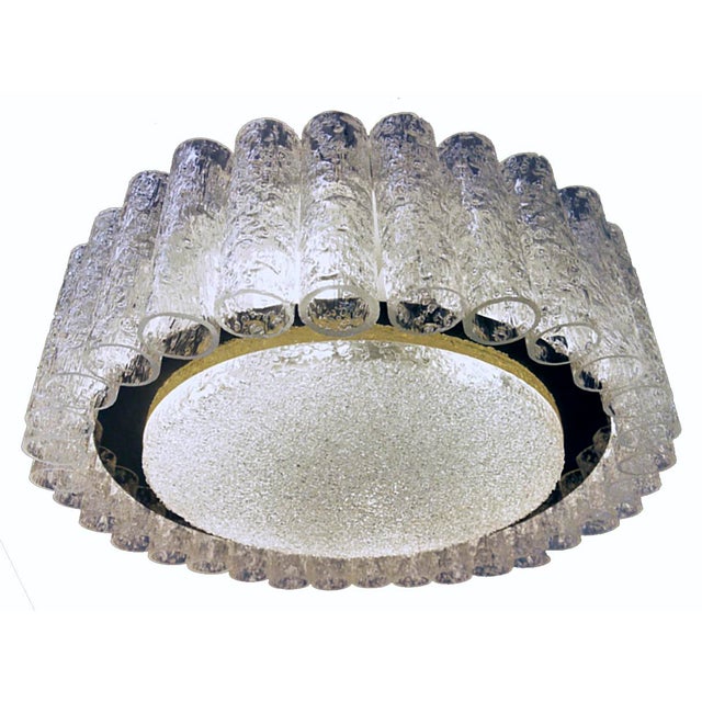 Elegant white laquered metal frame with in the center a structured glass disc, a brass ring and thirty two murano glass...