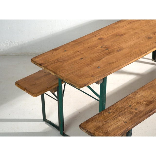 This antique beer garden set (bierzelt) in pine wood and painted steel features a long table and two matching benches, all...