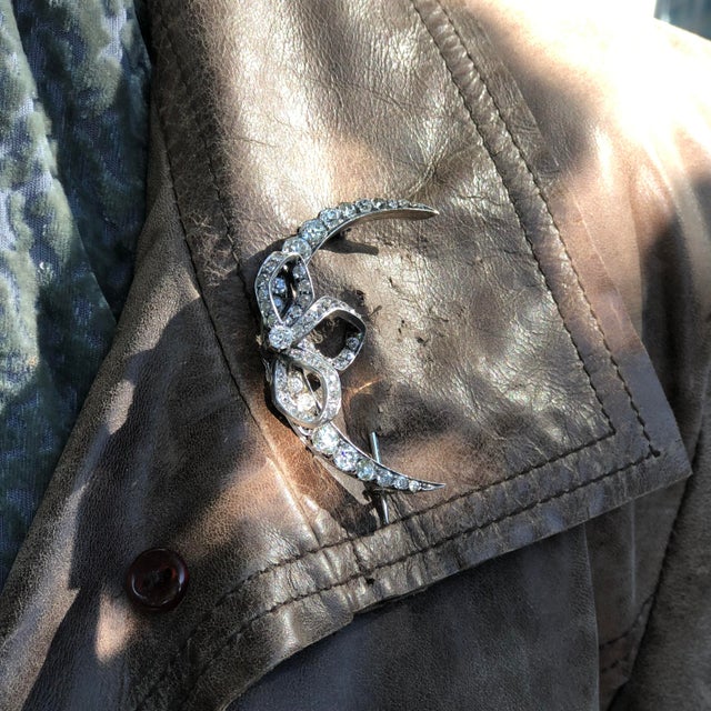 This is part of Chairish’s Fine Jewelry assortment. This enchanting brooch is shaped like a crescent moon adorned with a...