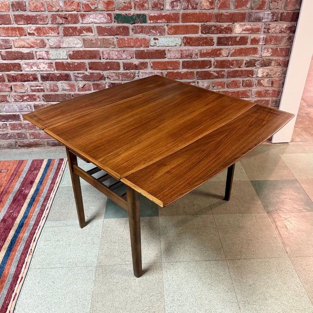 Vintage mid-century Scandinavian modern extending coffee table in walnut and beech, circa 1950s-60s. This restored table...