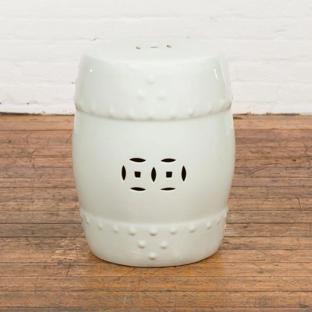 A Chinese vintage blanc de Chine ceramic garden stool from the mid 20th century, with pierced and raised motifs. Created...