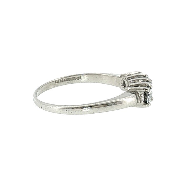 A late 20th-century platinum ring featuring four brilliant-cut white diamonds. The diamonds have a total carat weight of...