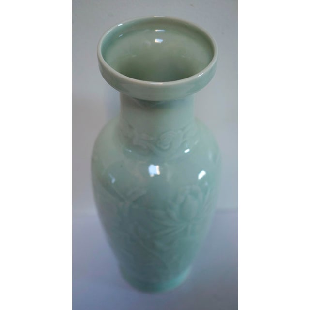 This baluster form celadon green vase is embossed with flowers and ferns. It is from a collection of estate sale vases and...