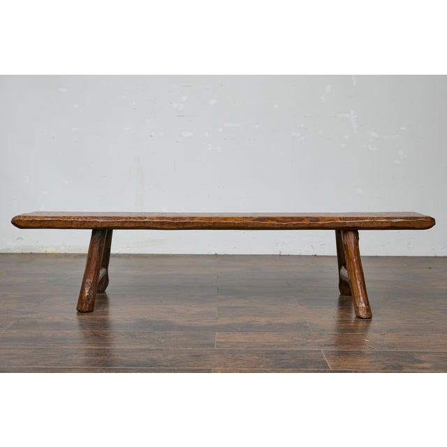 Crafted from solid pine with rustic charm, this American 20th-century bench showcases timeless craftsmanship. Its hand-...