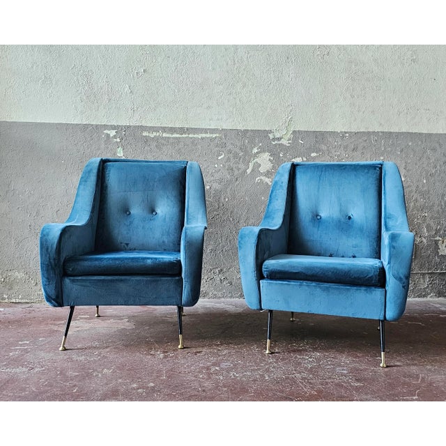 A refined pair of armchairs made in the mid-20th century. Recently restored in blue velvet, the armchairs are in excellent...