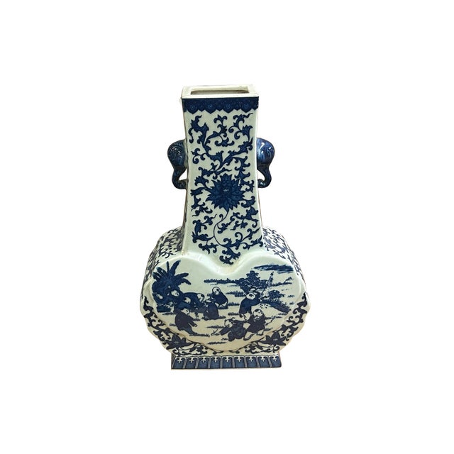 This exquisite porcelain vase features a classic blue-and-white color palette, combining intricate botanical patterns with...