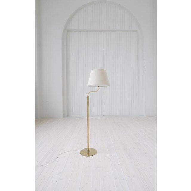 This Mid-Century Modern floor lamp were manufactured in Sweden for Luxus. The rounded base and rod are made in brass. The...