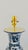 A 20th century table lamp made from a baluster shaped delfia vase. The white lamp is decorated with lush flowers, leaves...