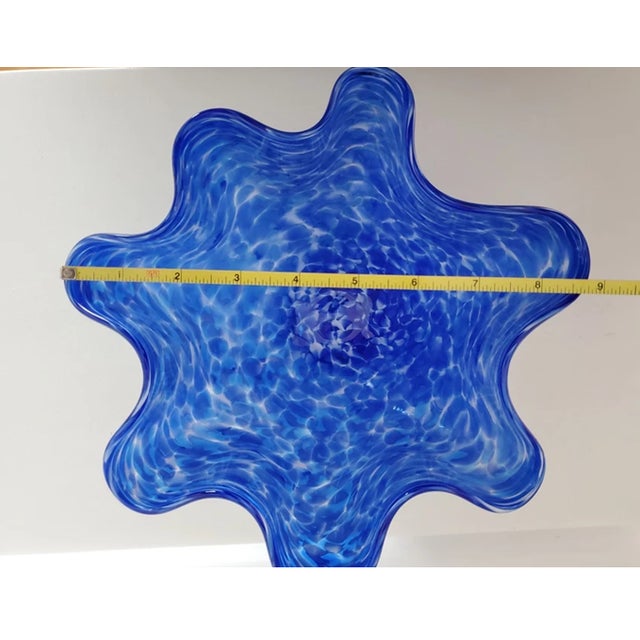 Elegant and timeless, this hand-blown handkerchief glass vase features a beautifully ruffled rim that mimics the soft...