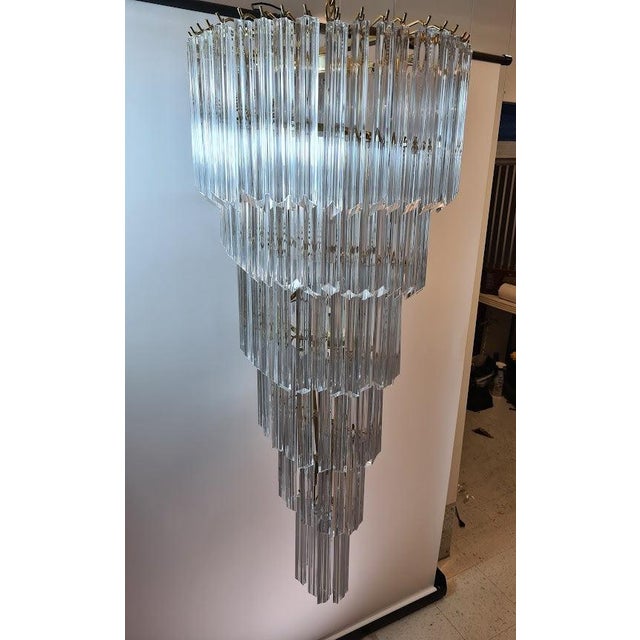 Vintage Italian&nbsp;Murano glass spiral chandelier, featuring a gilded brass frame and cascading clear glass prisms,...